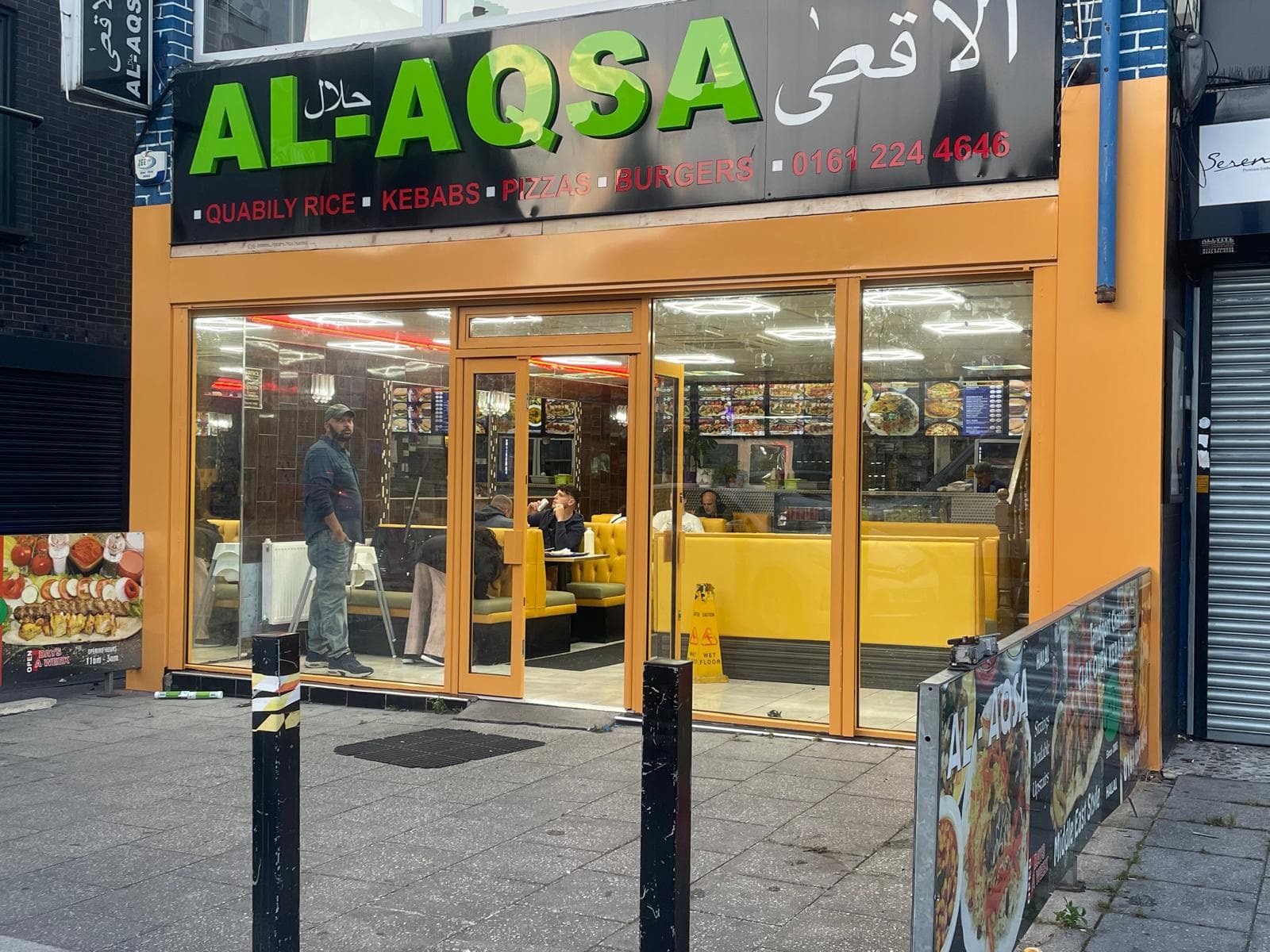Traditional aluminium shopfront with central entrance door