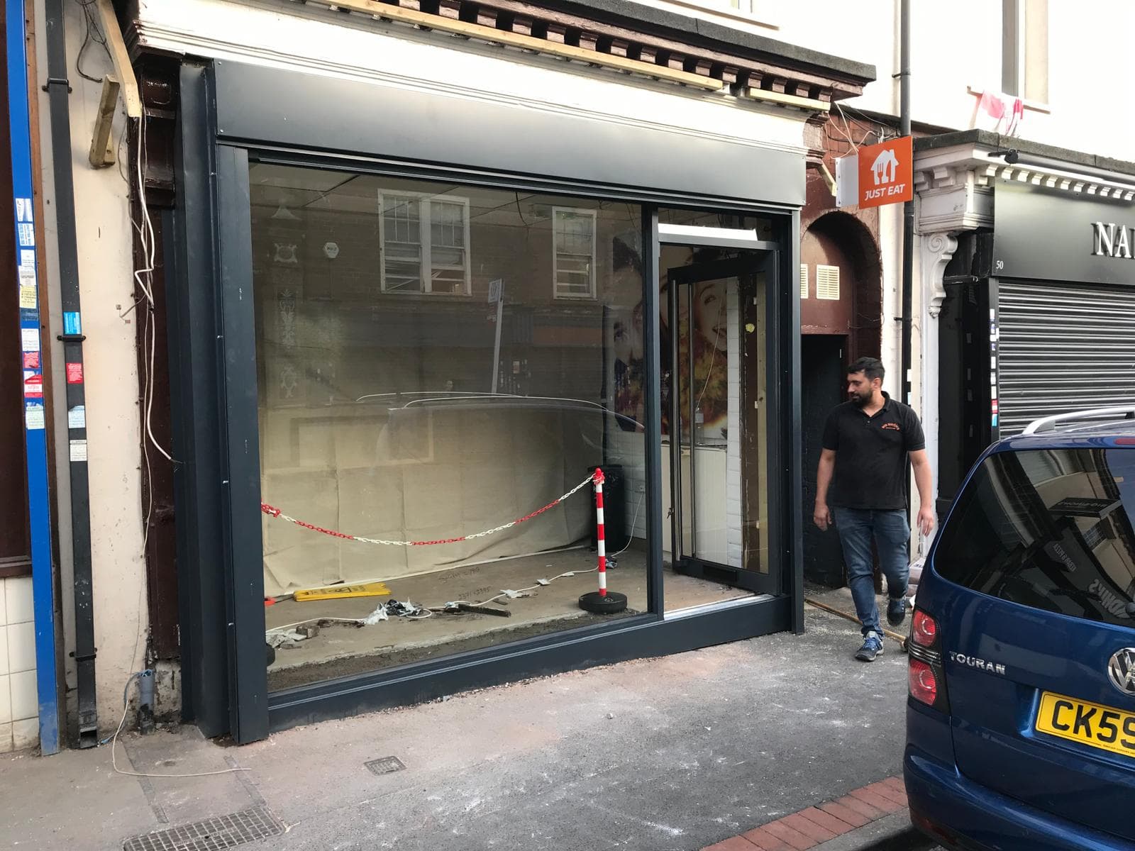 Modern shopfront design with tinted safety glass panels